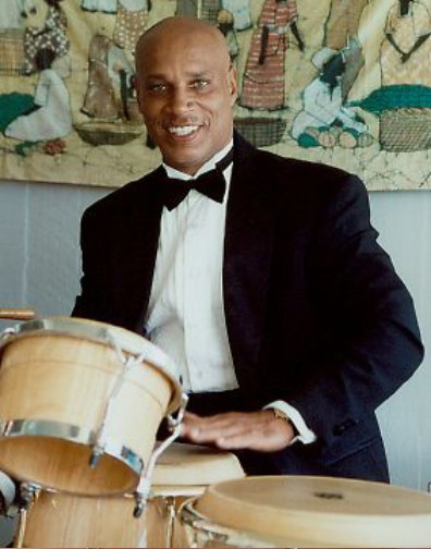 Babasango Posing with Drums in Suit